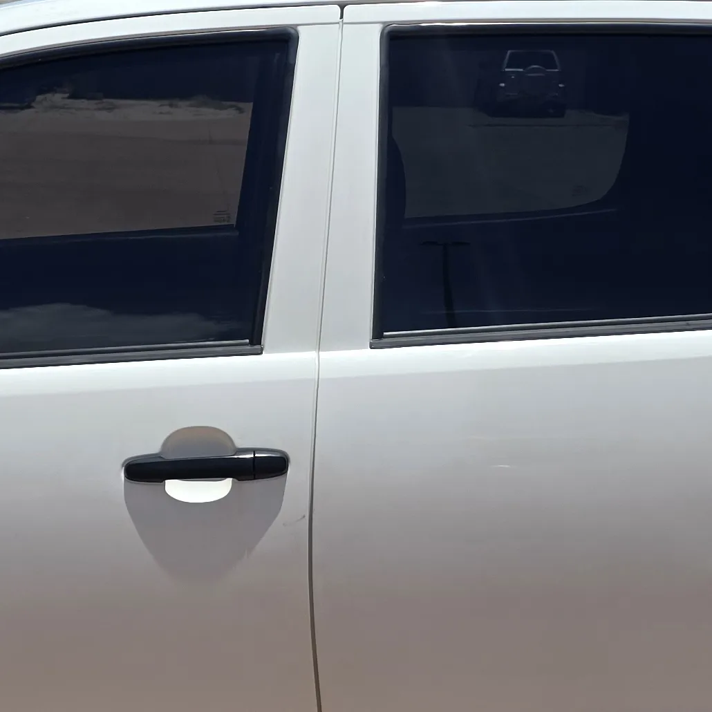 Side profile of white SUV showing professionally installed window tinting by Kimberley Auto Care