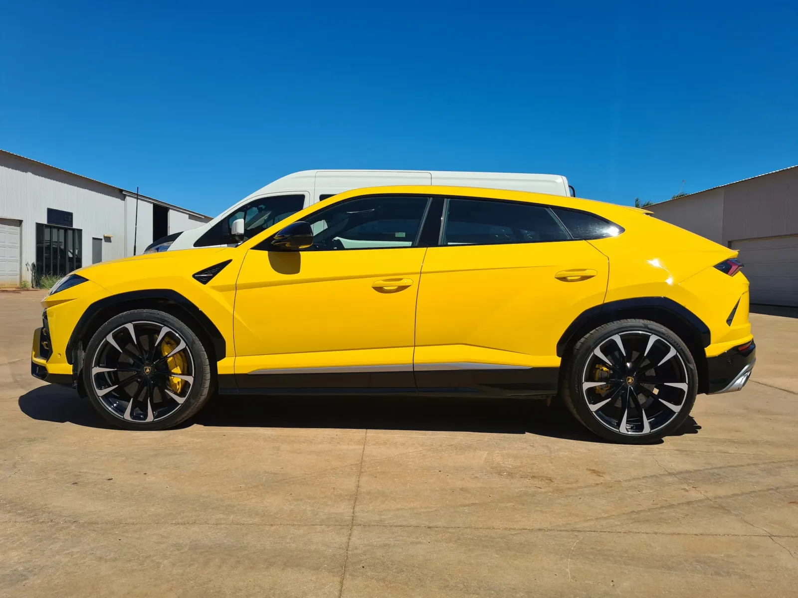 Yellow Lamborghini Urus super SUV with flawless paint and yellow brake calipers after professional detailing by Kimberley Auto Care