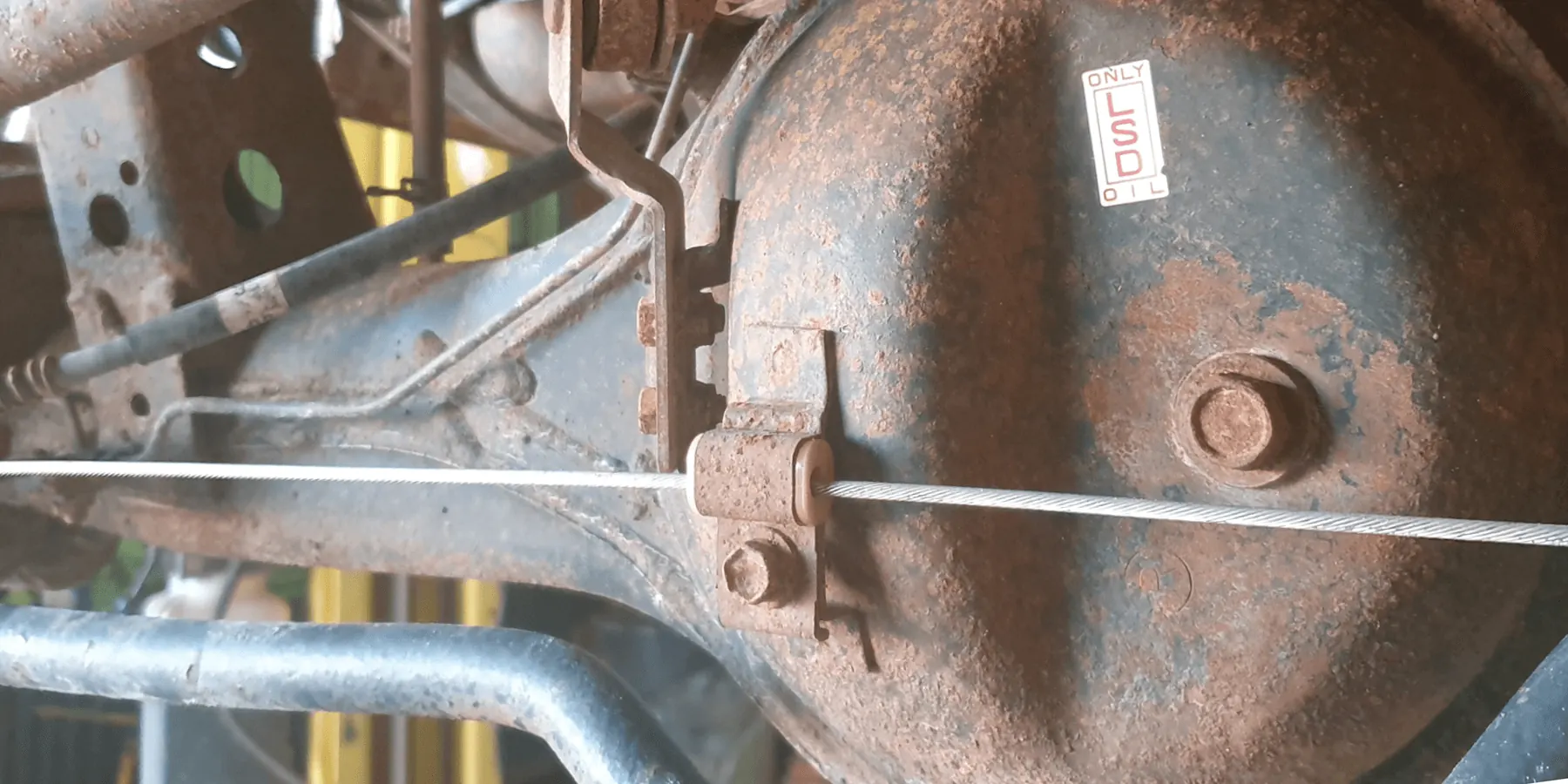 Heavily corroded rear LSD differential housing and suspension components covered in surface rust before rust proofing by Kimberley Auto Care