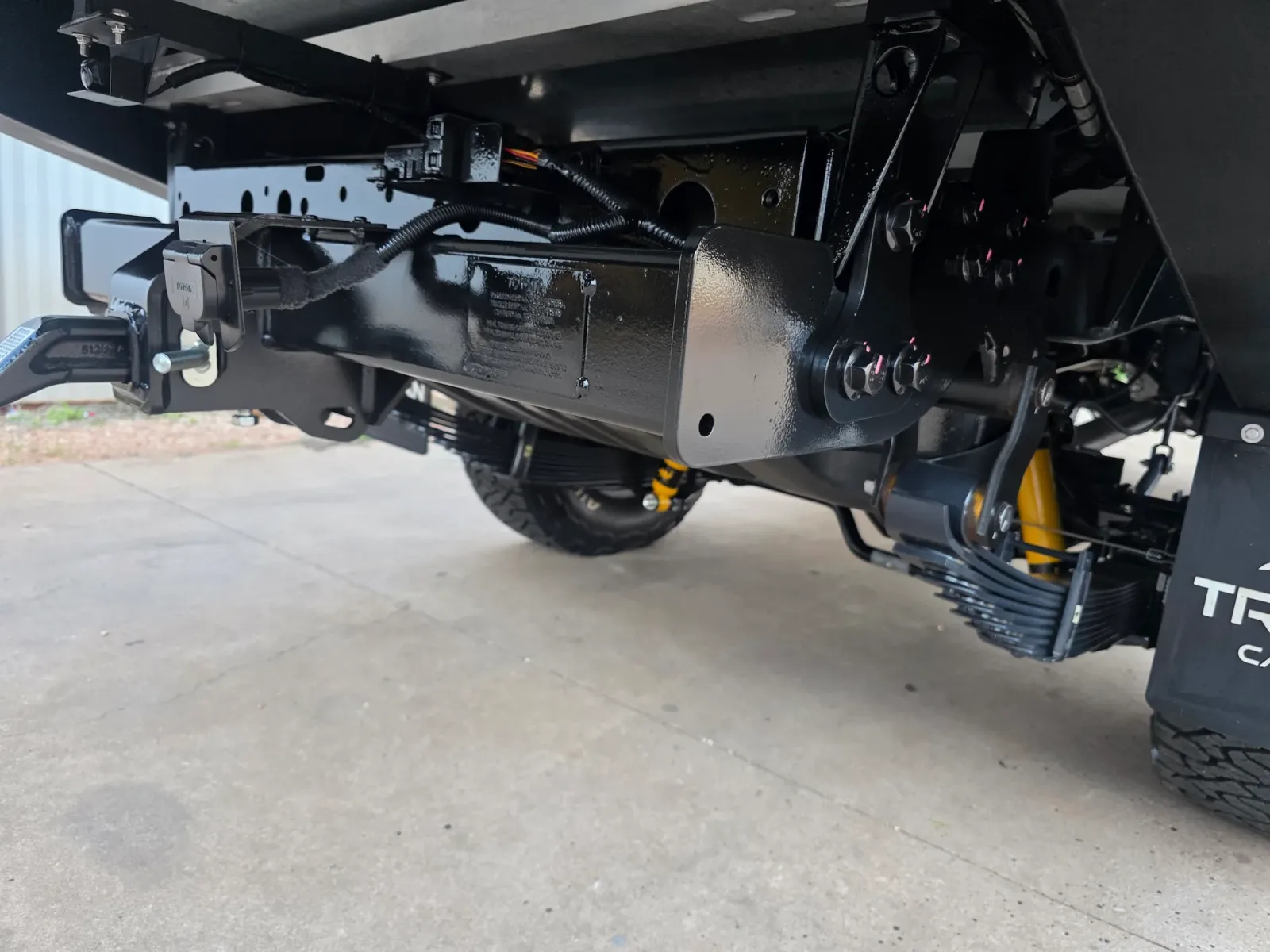 Rust-proofed rear chassis rail and cross member with Bilstein shock absorbers and leaf spring pack under canopy-fitted tray by Kimberley Auto Care