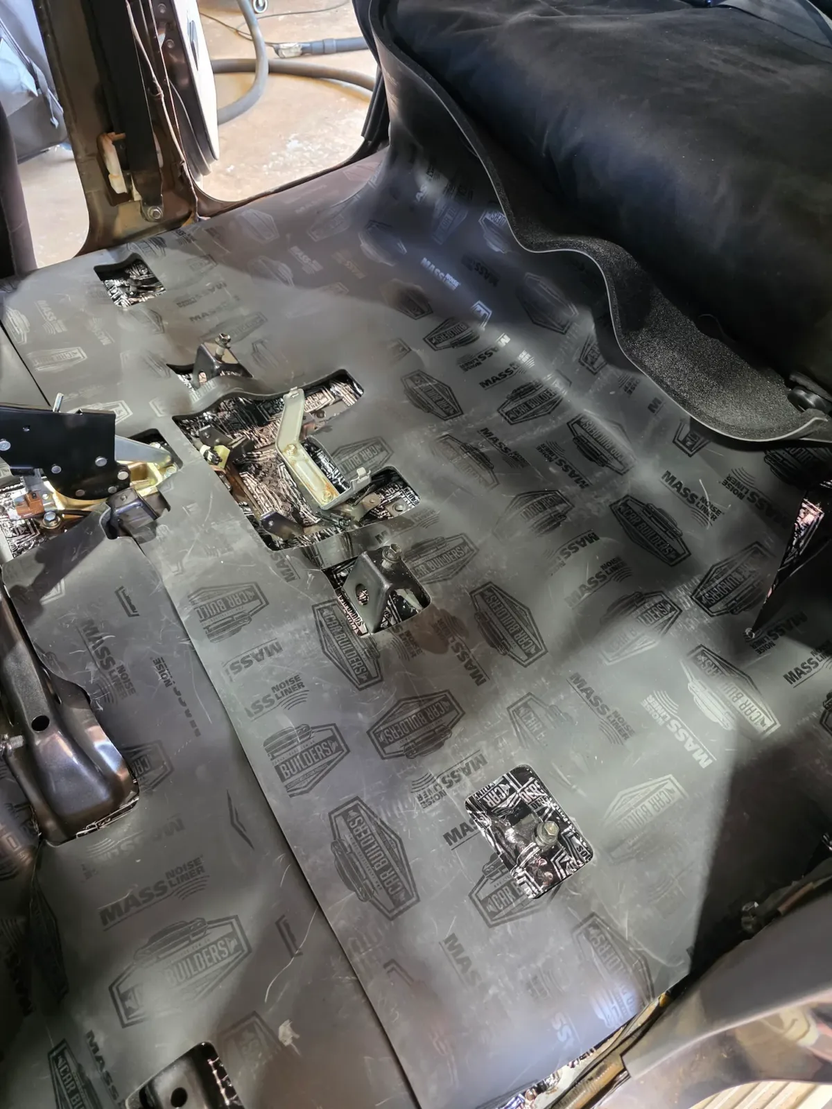 Sound deadening sheets applied across vehicle floor pan during cabin treatment at Kimberley Auto Care