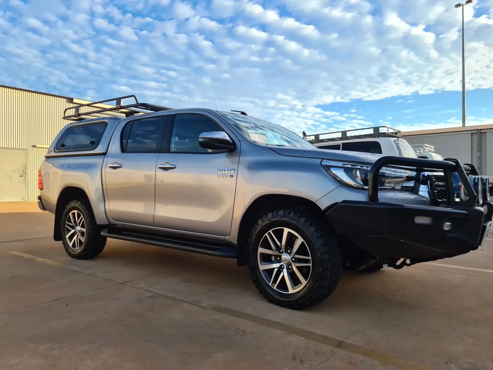 Silver Toyota HiLux SR5 dual cab with canopy, bull bar and roof rack -detailed and tinted by Kimberley Auto Care