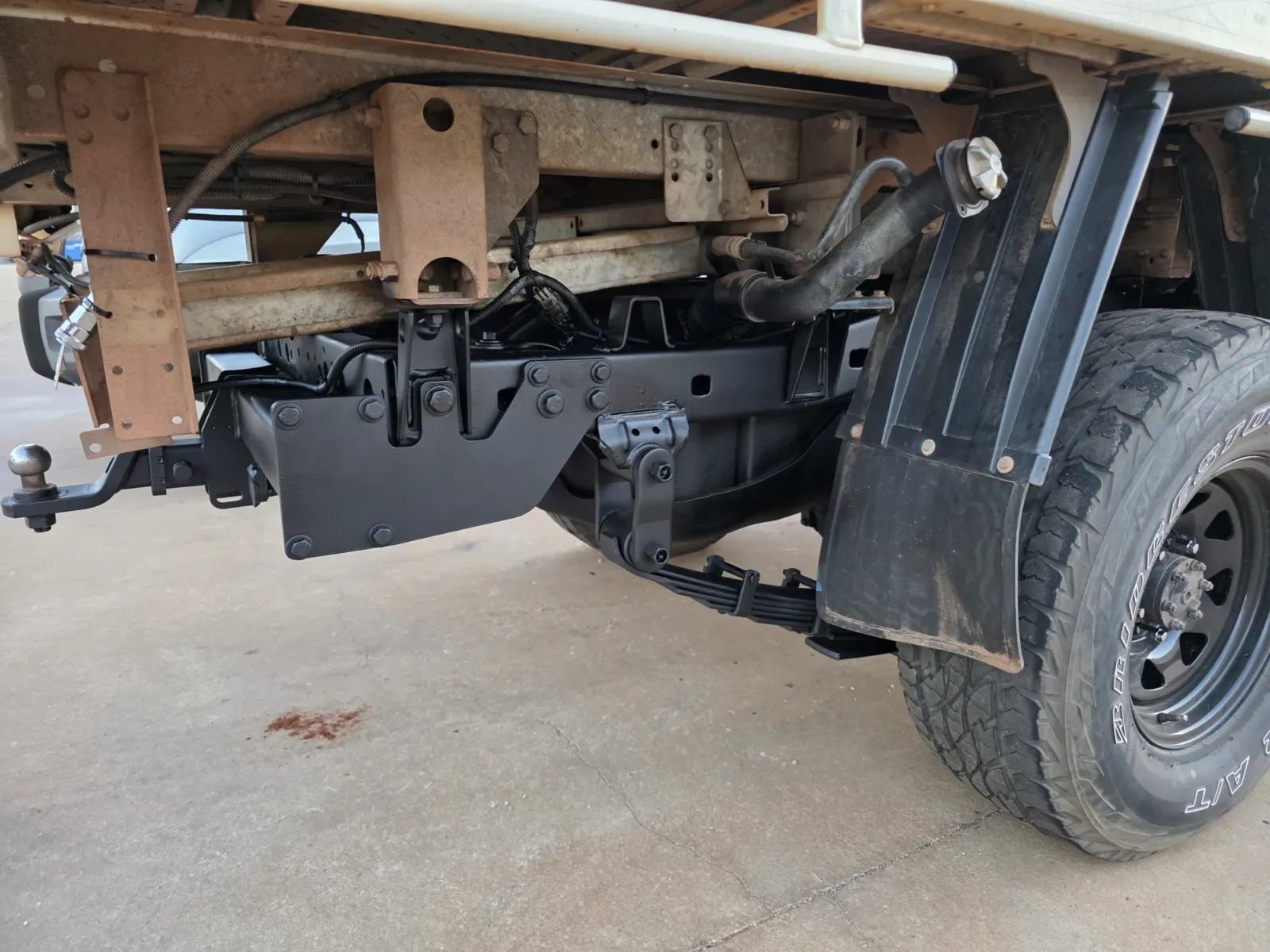 Underbody rust protection showing black protective coating applied to rear chassis, diff and suspension components on a 4x4 ute - applied by Kimberley Auto Care
